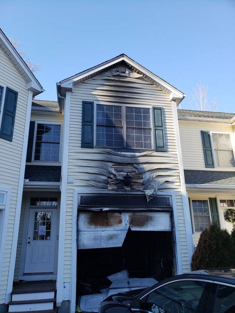 A garage after a fire. The siding is melting