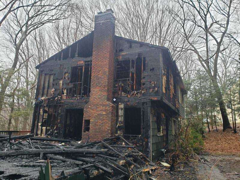 A home with a brick chimney after a house fire