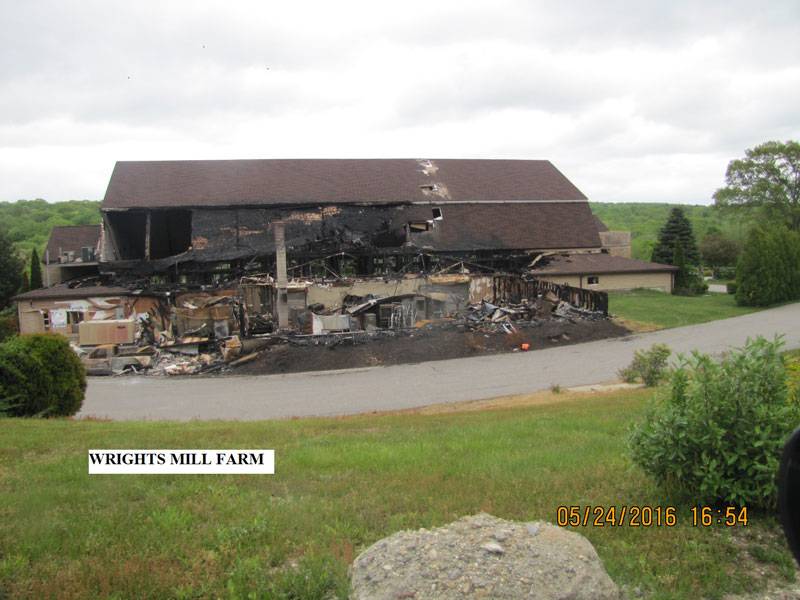 A burnt-down farm house with the caption: Wrights Mill Farm